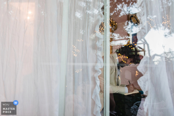 Photo by: <a href="https://www.wpja.com/contests/2020-v04/best-wedding-photographers/2605495">Nicky Byrnes - Carnelian Bay California</a> Topanga Canyon, CA wedding photo of The groom making last minute changes to his vows