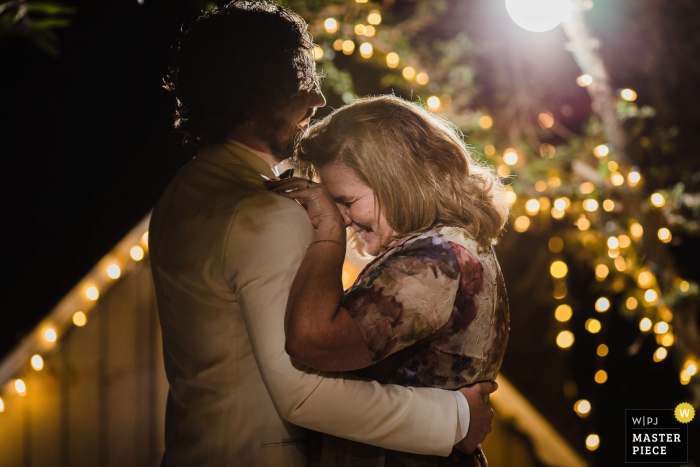 California wedding photography from the venue of Topanga Canyon, CA showing The groom and his mother enjoying a dance together