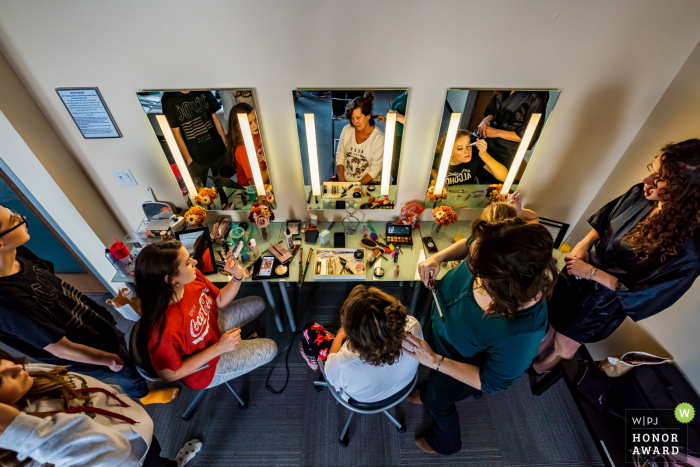 Colorado creative wedding photo from Windsong Estate, Severance of the bride and bridesmaids doing hair and makeup