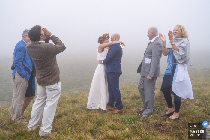 Buitenhuwelijksfotografie in Colorado van de eerste kus van de Ceremonie in mist