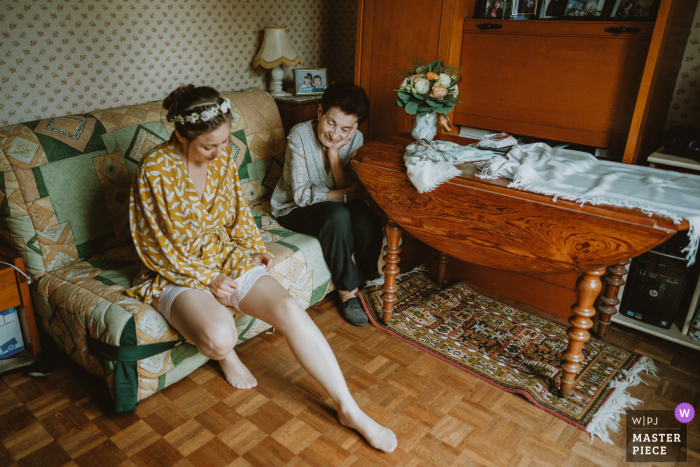 Photo by: <a href="https://www.wpja.com/contests/2020-v05/best-wedding-photographers/2609169">Audrey Morisson - Angouleme </a> France wedding photo from Beurlay of The bride putting on the garter