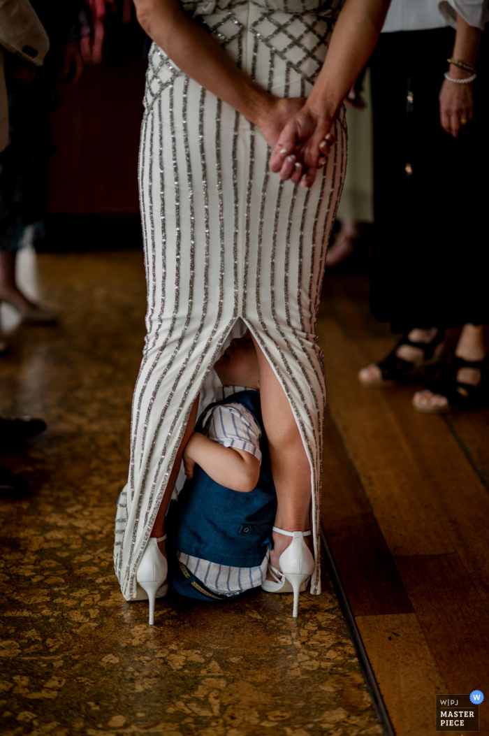 Photo by: <a href="https://www.wpja.com/contests/2020-v05/best-wedding-photographers/2609200">Gaelle Le Berre - Mount Waverley Victoria</a> Australia wedding photograph from Baths, Middle Brighton, Melbourne of Kids being Kids under the dress of mom