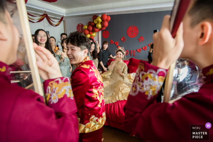 Foto di matrimonio in Cina di testimoni dello sposo a Hangzhou che giocano al gioco della porta