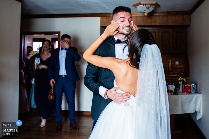 Wedding photo from Aglika Palace, Zhrebchevo, Bulgaria of the Groom crying tears of happiness to see the Bride