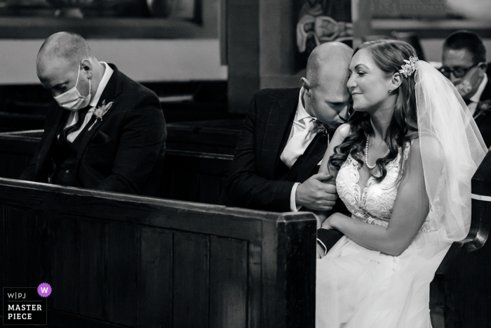 Lancashire huwelijksreportagefotografie van Clitheroe met een zachte kus tijdens een covid-ceremonie