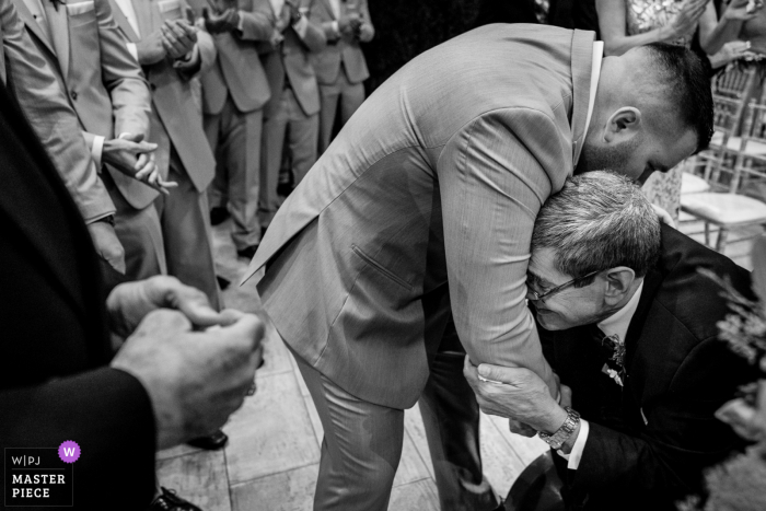 Pennsylvania wedding photo of the bride's father, who is suffering severely from multiple sclerosis, gives her away by pulling the groom in and whispered something to him that will forever stay between them