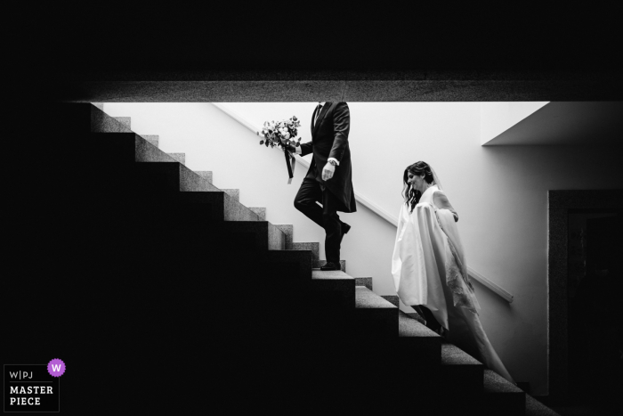 Black and white wedding photo from Peso da Régua, Quinta da Pacheca, Portugal of the bride heading up the stairs