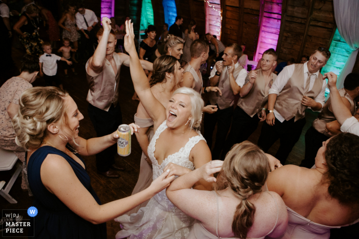 Photo by: <a href="https://www.wpja.com/contests/2020-v05/best-wedding-photographers/2610754">Adam Boole - St. Louis Park Minnesota</a> Wedding photography from The Vintage Garden, Barnseville, MN - bride dances with her guests in the barn
