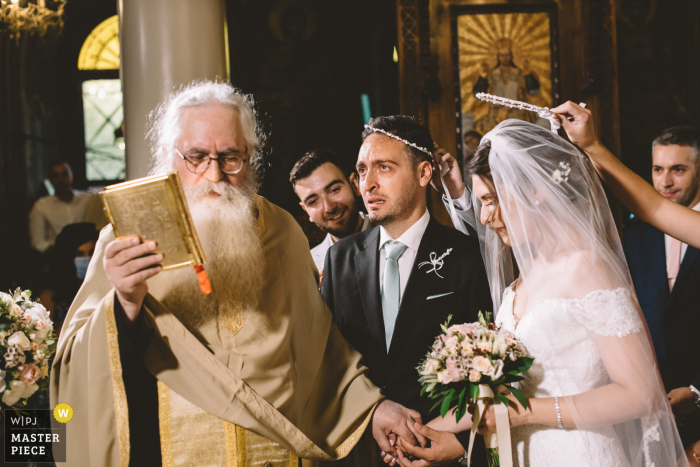 Fotografia di matrimonio Halkida, Grecia della sposa e dello sposo durante la cerimonia