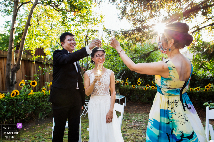 Photo by: <a href="https://www.wpja.com/contests/2020-v05/best-wedding-photographers/2610814">Chris Shum - Sunnyvale California</a> Wedding photograph from Oakland of a toast to the bride and groom