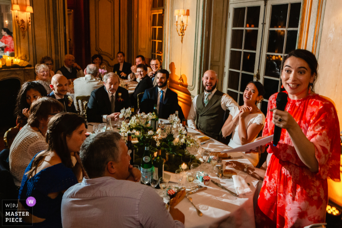 France Reception image of the bridemaid giving a speech to the bride and groom and guests