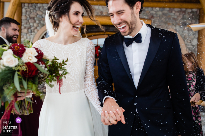 Big Sky, Montana wedding photo created as the bride and groom run through guests Big Sky, Montana wedding photo created as the bride and groom run through guests