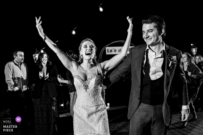 Della Terra Mountain Chateau, Estes Park, CO wedding photo showing the bride throwing her hands up on the dance floor