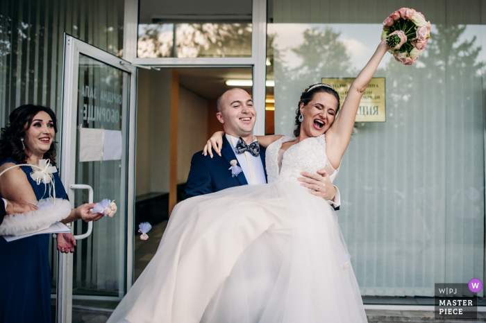 Sofia / Bulgaria wedding photo of the couple walking out and celebrating they are Legally married