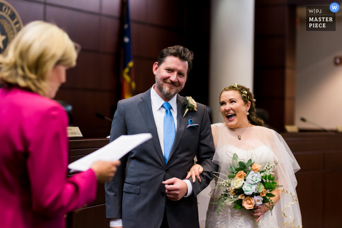 Fort Worth, TX wedding photography from the 2nd District Court of Appeals as A bride laughs during her civil ceremony Fort Worth, TX wedding photography from the 2nd District Court of Appeals as A bride laughs during her civil ceremony