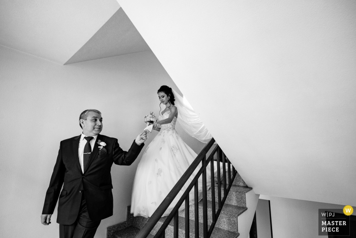 Sofia, Bulgaria wedding photography showing a traditional custom in which the father leads the bride out of her home