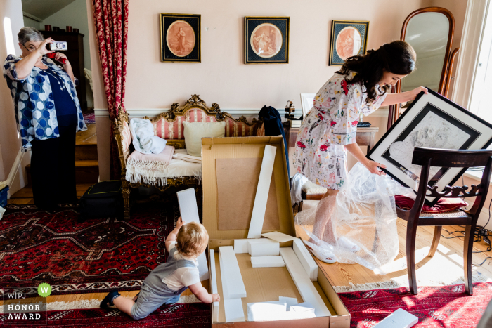 Ireland page boy helps bride open present from groom at the Gloster House