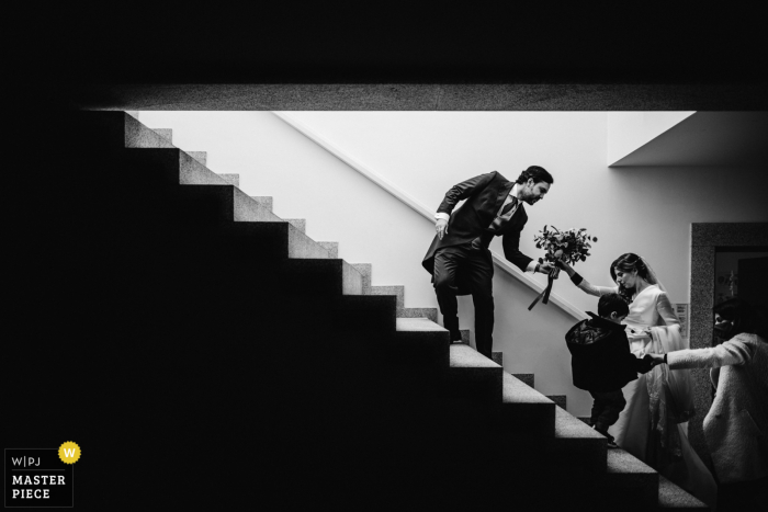 Peso da Régua - Quinta da Pacheca, Portugal wedding photo of the groom helping the bride climb the stairs