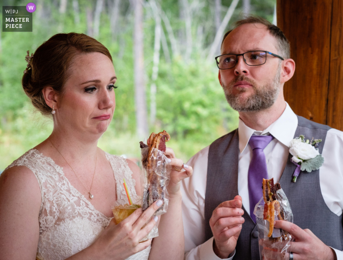 West Glacier, Montana wedding photography showing the bride and groom tasting the different favored bacon hors d'oeuvre. Because of COVID-19 all hors d'oeuvres had to be individually packaged West Glacier, Montana wedding photography showing the bride and groom tasting the different favored bacon hors d'oeuvre. Because of COVID-19 all hors d'oeuvres had to be individually packaged