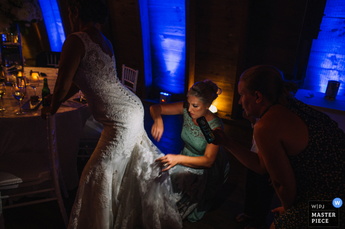  Sweeney Barn, Manassas, VA wedding photography of The sister and matron of honor is fixing some wardrobe issue