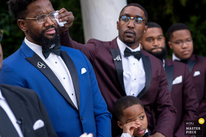 Delaware wedding ceremony image as the best man comforts emotional groom Delaware wedding ceremony image as the best man comforts emotional groom