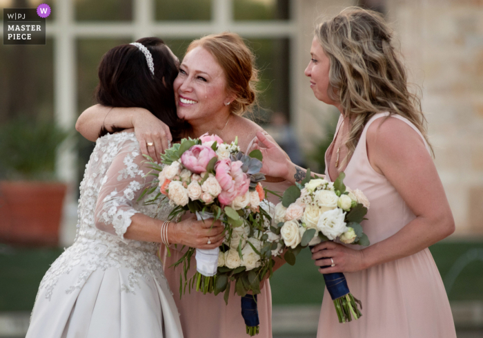 Arizona wedding photography showing bride hugging daughter in laws after ceremony Arizona wedding photography showing bride hugging daughter in laws after ceremony