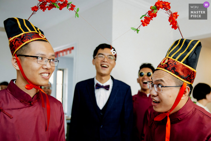 Beste Hochzeitsfotografie aus Guangxi, die ein Bild von Trauzeugen und dem chinesischen Bräutigam zeigt, der Türspiele spielt