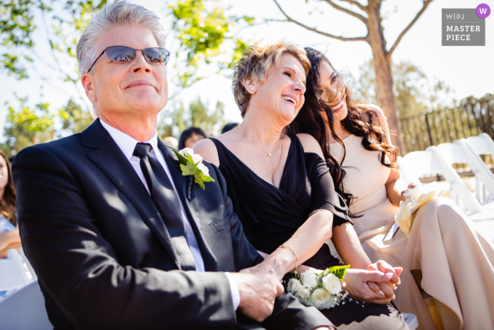 Sky Ranch Lodge, Sedona Arizona wedding photography showing Brides mother, father, and bridesmaid watch on during wedding ceremony Sky Ranch Lodge, Sedona Arizona wedding photography showing Brides mother, father, and bridesmaid watch on during wedding ceremony
