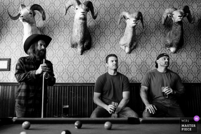 A top wedding photographer in Emigrant, Montana captured this picture in BW of Groomsmen playing pool A top wedding photographer in Emigrant, Montana captured this picture in BW of Groomsmen playing pool