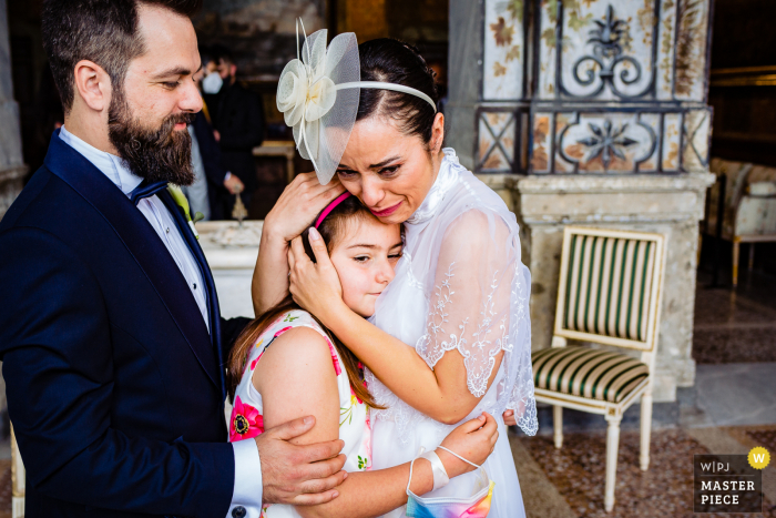 An Italian wedding photographer at Palazzo Chigi in Ariccia created this image showing The bride couldn't stop crying while hugging her cousin  