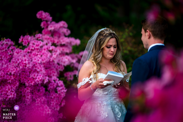 A wedding photographer at the National Arboretum in DC created this image showing The bride cries during her elopement ceremony A wedding photographer at the National Arboretum in DC created this image showing The bride cries during her elopement ceremony