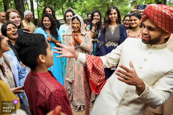 Wedding photography from Historic Polegreen Church showing Negotiations continue during shoe game following Nikkah Ceremony 