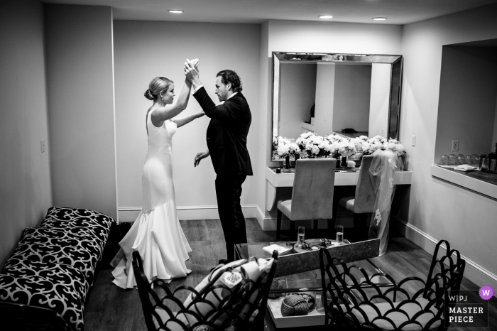 Wedding photography from Wychmere Beach Club, Harwich, MA showing The bride and groom practice their first dance before the reception 