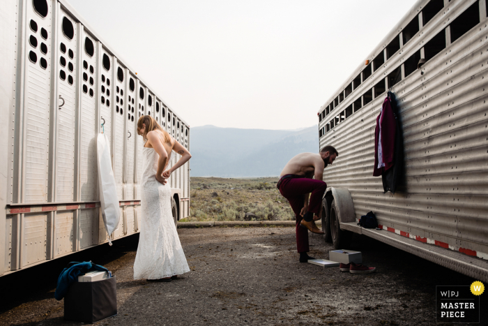 Lamar Valley, Yellowstone marriage preparation time award-winning picture capturing the elopement couple getting ready together. The world's best wedding image competitions are held by the WPJA