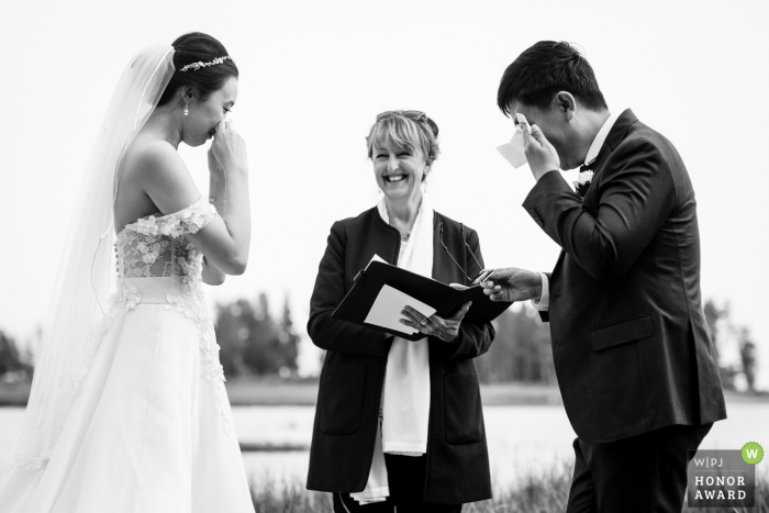 The Wyoming WPJA is proud to award this non traditional and emotional Yellowstone wedding picture showing the WY bride and groom cry after reading vows 