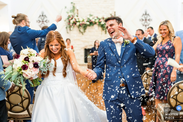 Potomac Winery, Stafford, VA indoor marriage award-winning image showing the Couple recesses from their ceremony