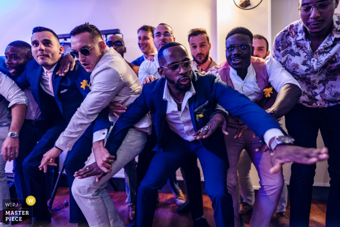 Photo by: <a href="https://www.wpja.com/contests/2021-v02/best-wedding-photographers/2632066">Luan Nguyen - Paris </a> Domaine de l'Orangerie, France indoor wedding reception party award-winning picture showing Grooms friends during a dance battle