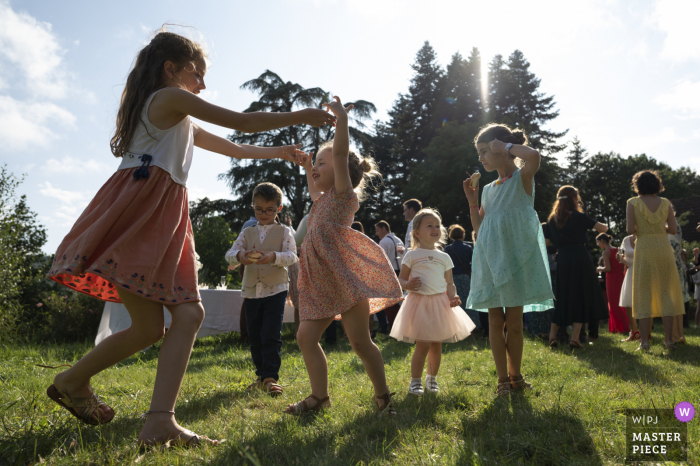 Manoir de Plainartige outdoor marriage reception party award-winning photo that has recorded kids playing outdoors Manoir de Plainartige outdoor marriage reception party award-winning photo that has recorded kids playing outdoors