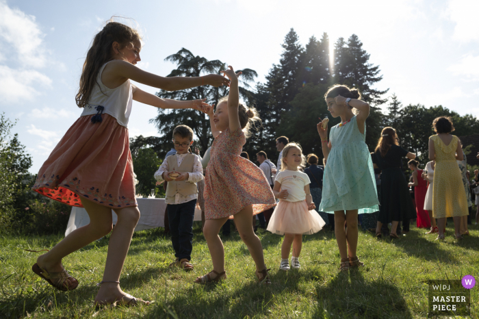 Manoir de Plainartige outdoor marriage reception party award-winning photo that has recorded kids playing outdoors