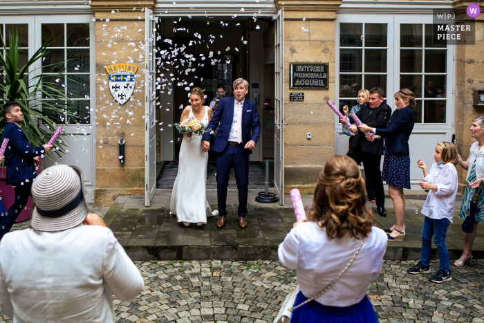 Mairie de Moulins nuptial day award-winning image of The exit of the town hall under the rain of confetti and the scary cannons