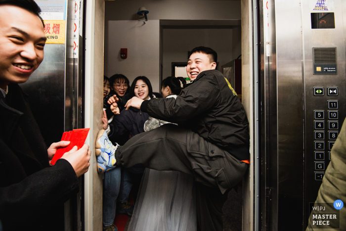 Fujian nuptial day award-winning image of Relatives and friends preventing the groom from entering the new house