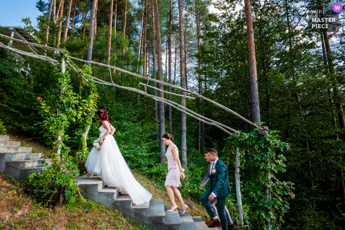 Photo by: <a href="https://www.wpja.com/contests/2021-v02/best-wedding-photographers/2633207">Bozhidar Krastev - Ruse Ruse</a> Raiski Zaliv, Goliama Zheliazna, Bulgaria outdoor marriage award-winning image showing The Bride on her way to the Ceremony