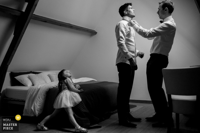 't Goed Indoye marriage preparation time award-winning picture capturing the groom getting his tie fixed. The world's best wedding image competitions are held by the WPJA