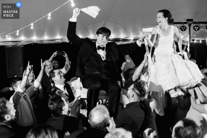 Elm Bank, Wellesley, MA outdoor marriage reception party award-winning photo that has recorded an exciting horah dance. The world's top wedding photographers compete at the WPJA