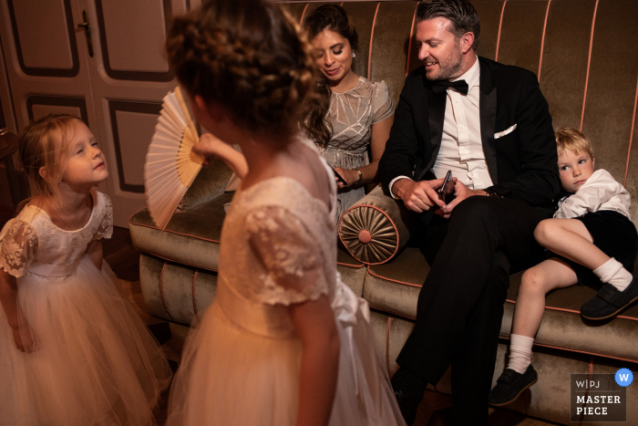 Lake Como, Italy nuptial day award-winning image of kids having fun and relaxing. The world's best wedding photography competitions are hosted by the WPJA