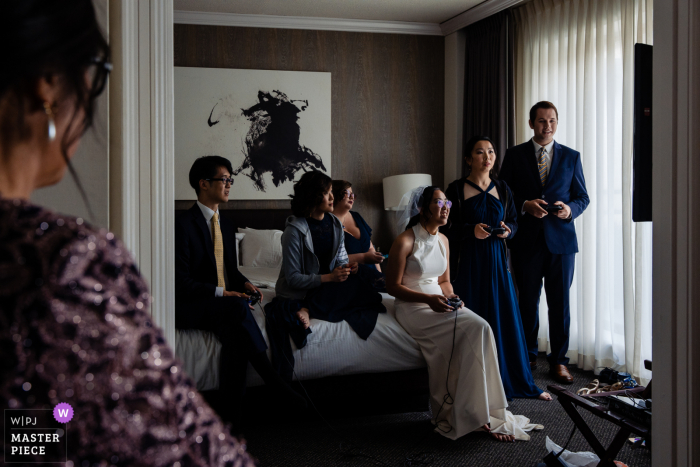 Philadelphia getting ready for marriage award-winning picture capturing the Mother of the bride nervously watching her daughter/bride play super smash bros with her wedding party when she knows they should be leaving for the ceremony