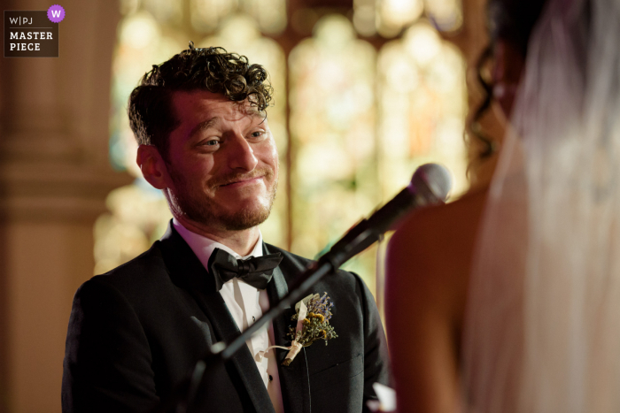 Igreja de St. Jax, imagem vencedora do prêmio da cerimônia de casamento em Montreal mostrando Um noivo emocionado ouvindo sua noiva lendo seus votos - nos melhores concursos de fotografia de casamento do mundo apresentados pela WPJA