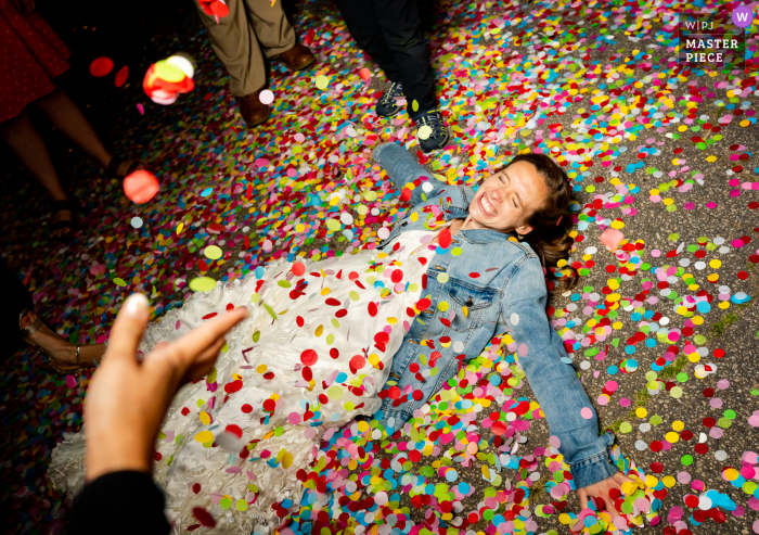 Wake Forest, North Carolina marriage reception party award-winning photo that has recorded The bride makes angels in confetti after their special exit - from the world's best wedding photography competitions offered by the WPJA