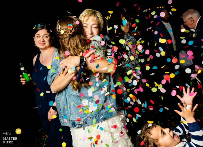 Photo by: <a href="https://www.wpja.com/contests/2021-v02/best-wedding-photographers/2635181">Autumn Parry - Fort Collins Colorado</a> Wake Forest, NC marriage reception party award-winning photo that has recorded Bride hugging her mother at the end of her wedding day - from the world's best wedding photography competitions offered by the WPJA