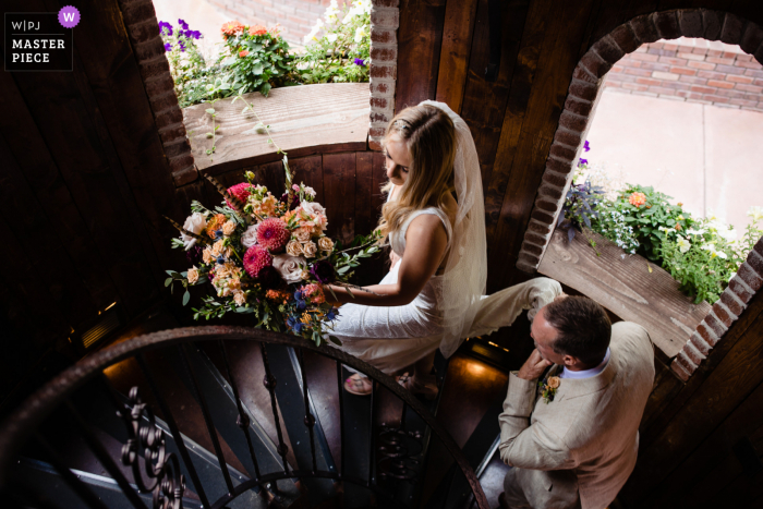 A Larkspur documentary wedding photographer captured this moment of the bride Walking to the ceremony up spiral stairs A Larkspur documentary wedding photographer captured this moment of the bride Walking to the ceremony up spiral stairs